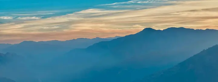 Layered peaks — misty mountain range
